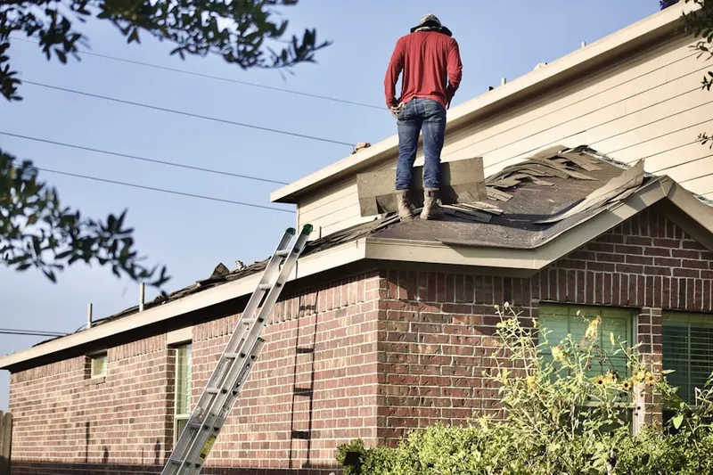 Professional roofer working on a residential roof in Lorton
